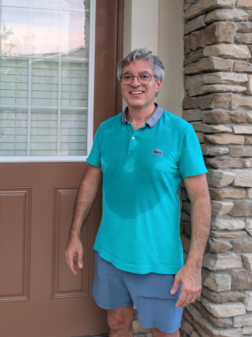 Issam beside a freshly refinished front entry door — Specialty Home Painting Orlando